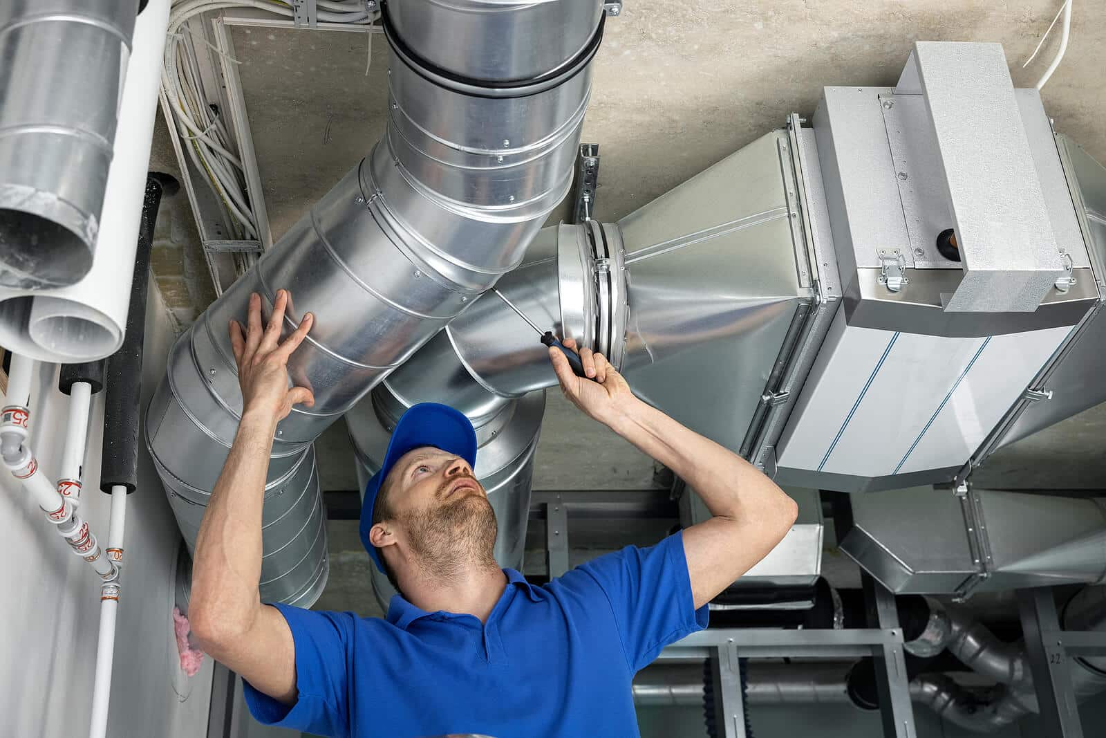 HVAC technician inspecting and repairing air ducts in West Covina