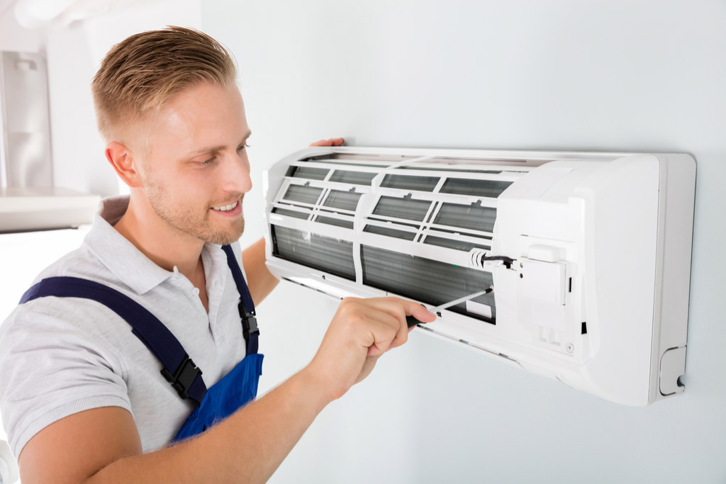 HVAC technician maintaining a ductless air conditioner in West Covina