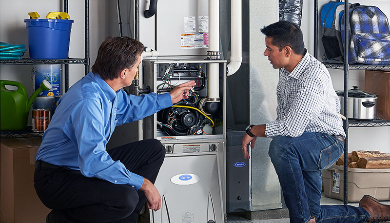 Technician evaluating a furnace for repair or replacement in West Covina