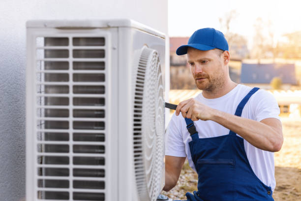 HVAC technician servicing an outdoor air conditioner in West Covina