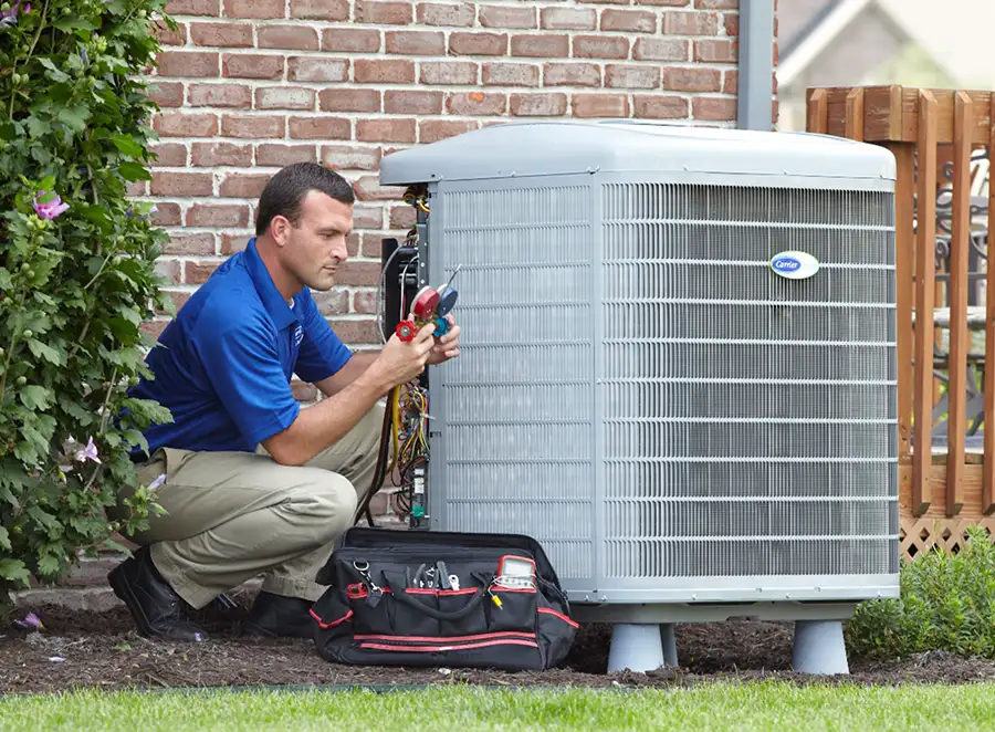 HVAC technician inspecting an outdoor AC unit in West Covina