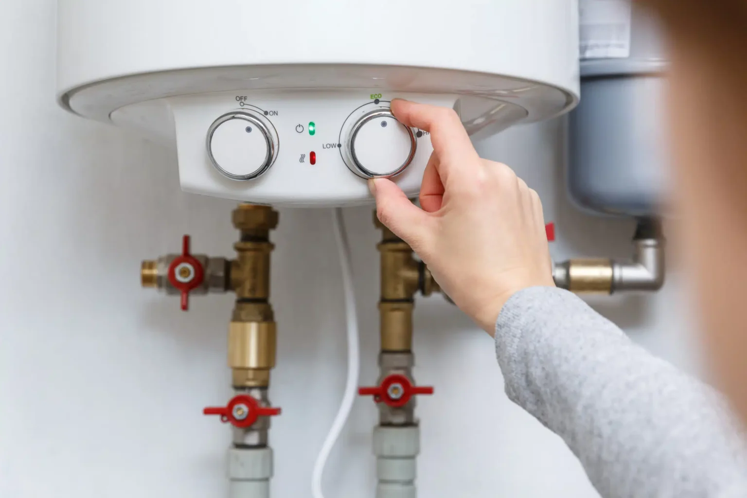 Technician adjusting a water heater in West Covina